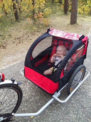 Isla in her bike trailer